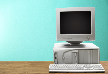 Obsolete computer set on light blue background