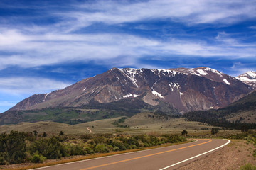 Road to the Mountains
A road in the Eastern Serria Nevada that leds a mountain range. Blue cloudy sky with light snow cap on the mountian. 