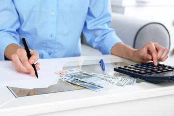 Fototapeta premium Accounting concept.Analyzing finance report with calculator