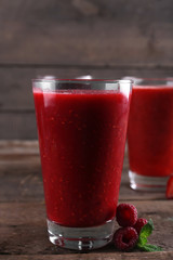 Berry cocktails and fresh berries on wooden background