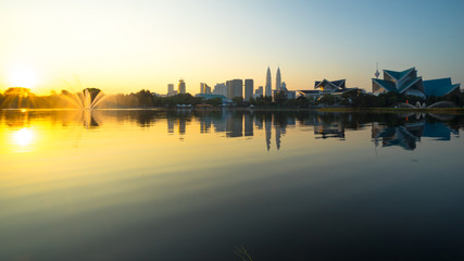 KUALA LUMPUR, MALAYSIA - FEBRUARY 20, 2015:  Sunrise view of Kuala Lumpur at Lake Titiwangsa, Malaysia.The lake  is located just beside the busy Jalan Tun Razak in the heart of Kuala Lumpur, Malaysia.