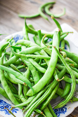 raw green beans on a gray wooden table,.healthy food