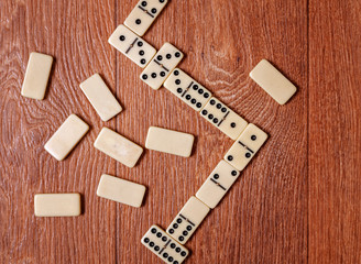 domino pieces on the brown wooden table background