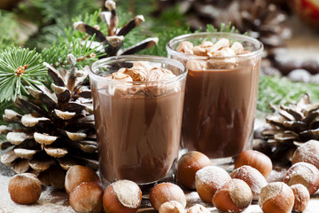 Festive chocolate mousse with nuts, decorated with pine cones an
