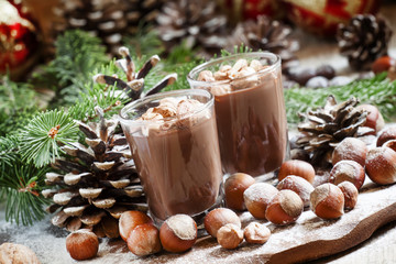 Festive chocolate mousse with nuts, decorated with pine cones an