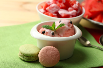 Watermelon ice cream in bowls and fresh watermelon pieces  on color wooden background