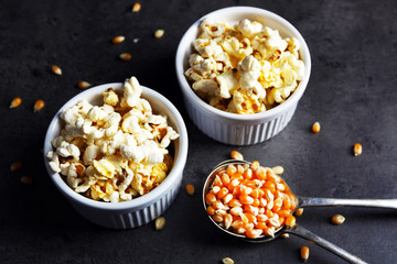 Obraz na płótnie Canvas Popcorn in bowls on dark background