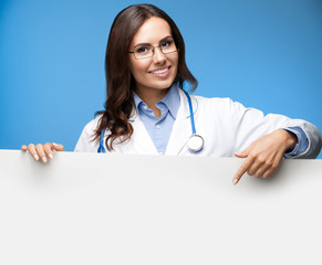 female doctor showing blank signboard, over blue