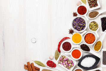 Various spices on white wooden background