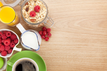 Obraz na płótnie Canvas Healty breakfast with muesli, berries, orange juice, coffee and