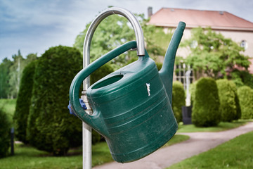 watering can hanging on faucet