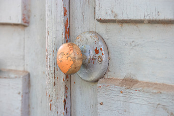 Wood Door handle on obsolete wooden background.