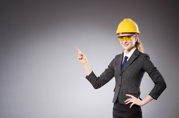 Construction worker in helmet against gray