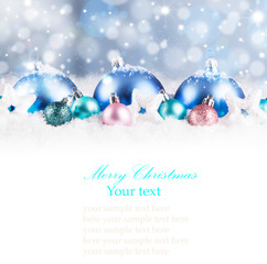 Fototapeta na wymiar Christmas background with blue baubles,snow and snowflakes, free space for text. Christmas decoration. 