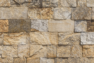 The wall of stone blocks, different surfaces.