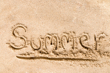 Summer text write on sand at the beach, Summer concept.