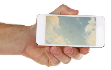 Hand holding mobile smart phone with sky in screen. Cloud computing concept