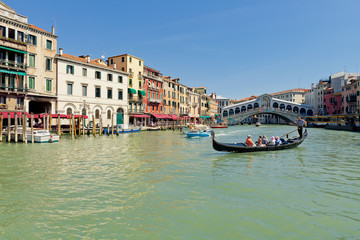 Grand Canal with traditional Gondola near famous Rialto bridge in Venice, Italy