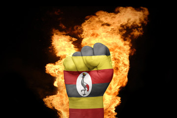 fire fist with the national flag of uganda