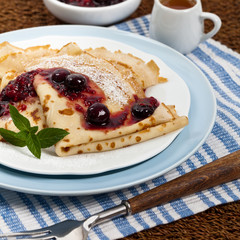 Blintzes or Pancakes with Blueberries. Selective focus.