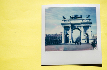 Instant photo on colored yellow background. Polaroid Milan