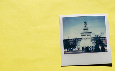 Instant photo on colored yellow background. Polaroid Milan