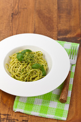 Spaghetti with pesto and basil. Selective focus.