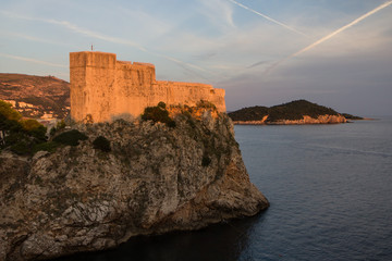 Fototapeta na wymiar View of Fort Lovrijenac (St. Lawrence Fortress) on top of a steep cliff in Dubrovnik, Croatia, at sunset.