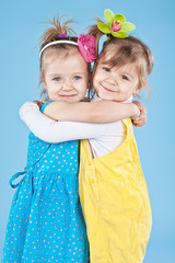 two little sisters in color clothes 