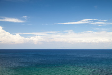 Seascape with blue water and cloudy sky