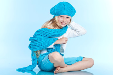 Beautiful girl in blue winter beret