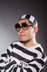 Young prisoner against gray