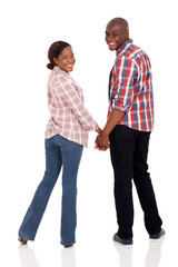 african american couple holding hands and looking back