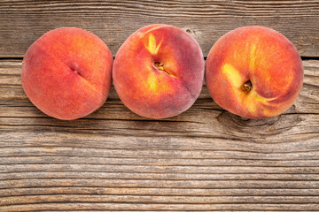 peach fruits on weathered wood