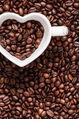 White cup on coffee beans background