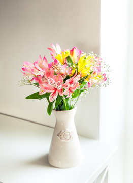 Fototapeta Alstroemeria flowers in vase on table