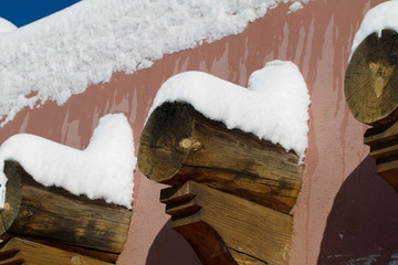 Adobe walls, vigas, snow, blue sky, winter in Santa Fe, New Mexico © Martha Marks