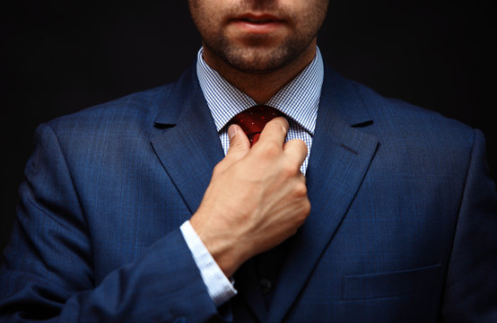 Well Dressed Business Man Adjusting His Neck Tie