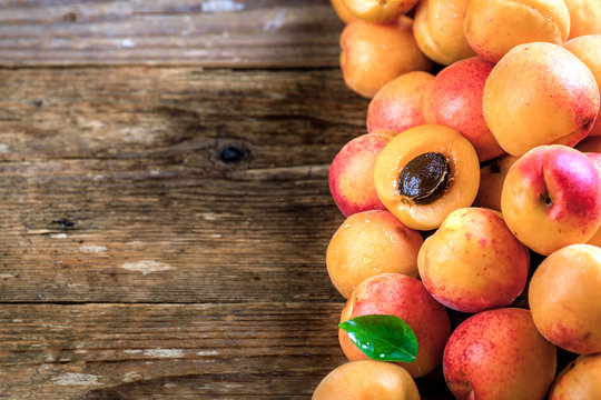 Apricot. Organic fruits with leaf on wooden background