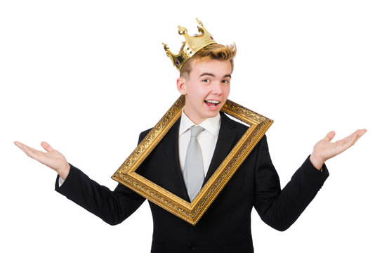 Young businessman with crown and picture frame isolated on white