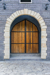 Fototapeta na wymiar Wooden door in stone wall