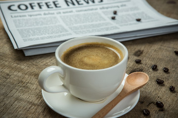 Close up glasses on newspaper and Coffee on the wooden table in