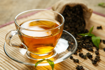 Tea and leaves tea on bamboo placemat
