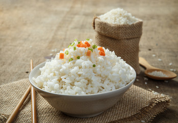 Steamed rice close-up with chopsticks on burlap