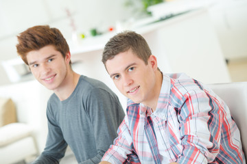 Two guys chilling on the sofa