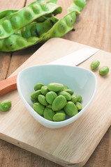 Bitter bean on the white dish and wood floors.