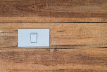 White switch on wooden wall