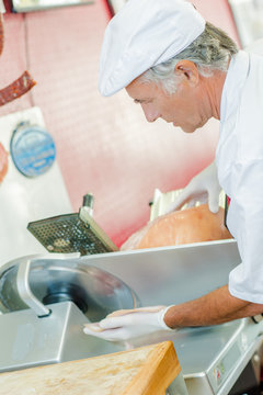 Man using meat slicing machine