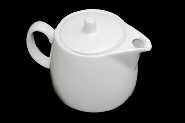 White teapot on a black background