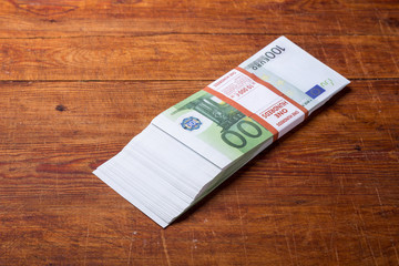 Close-up of  100 Euro banknotes on wood background